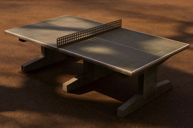 Outdoor ping pong table on a brown surface in natural light, perfect for an active outdoor lifestyle and recreational activities.