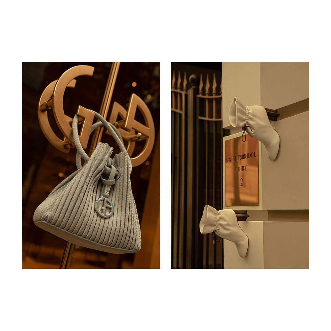 Luxurious light grey Armani handbag displayed on a gold door handle, paired with an elegant shoe display for a high-fashion aesthetic.