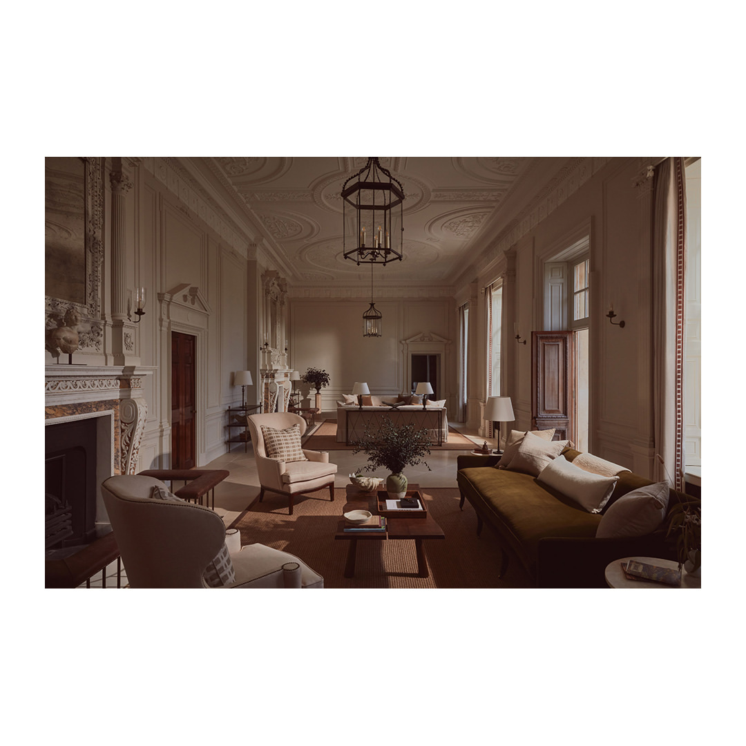 Luxurious living room interior features elegant seating, fireplace, lighting fixtures, and sophisticated decor in a spacious, well-lit setting.