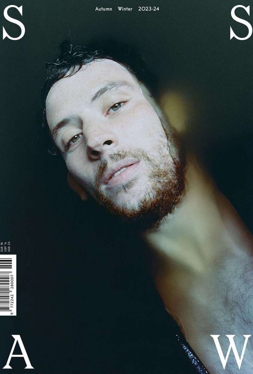 Magazine cover featuring a close-up portrait of a bearded man partially submerged in water, with 'Autumn Winter 2023-24' text.