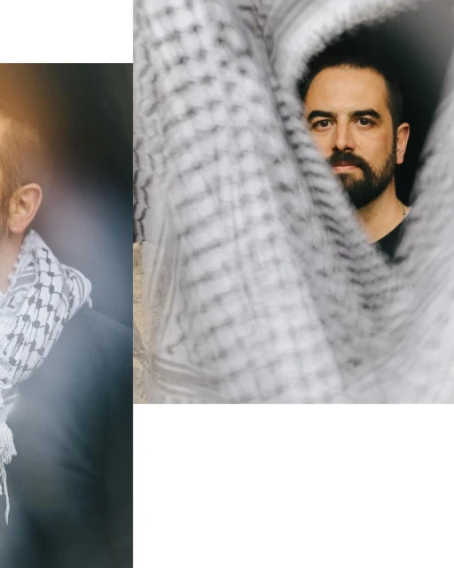 Two adult men pose with patterned white keffiyeh scarves indoors. One is visible through the scarf, another is partially visible.