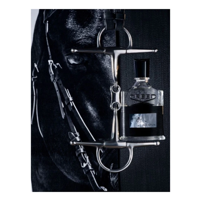 Equestrian-themed fragrance bottle hanging from a horse's bridle against a dark backdrop, highlighting the connection between luxury and equestrian sports.