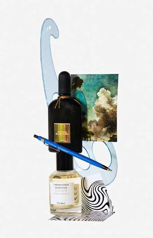 Still life product photography featuring black and clear perfume bottles, a blue pen, a drafting tool, and an art print against white.