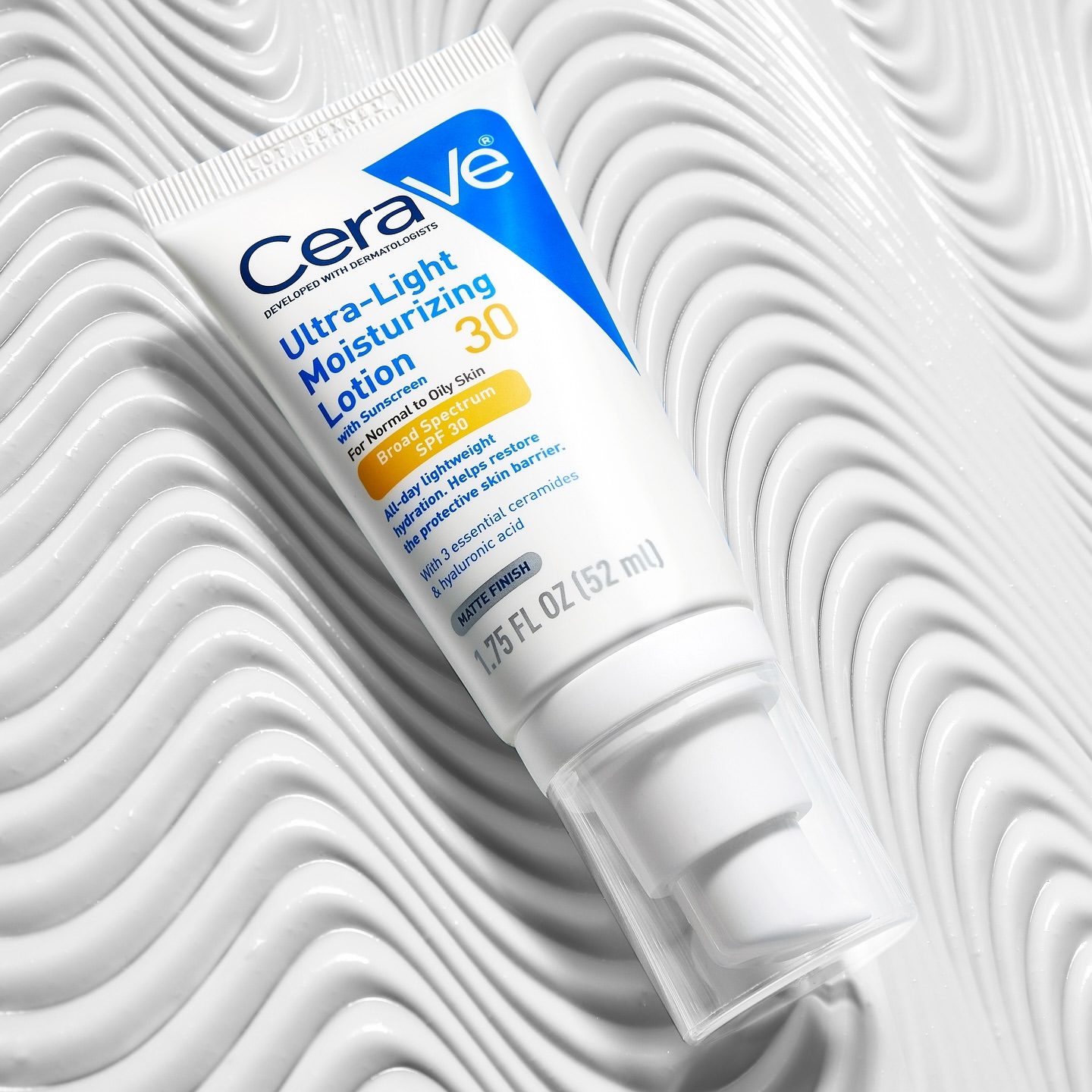 Cerave Ultra-Light Moisturizing Lotion SPF 30 shown against a white textured surface. Beauty, skincare, and sun protection.