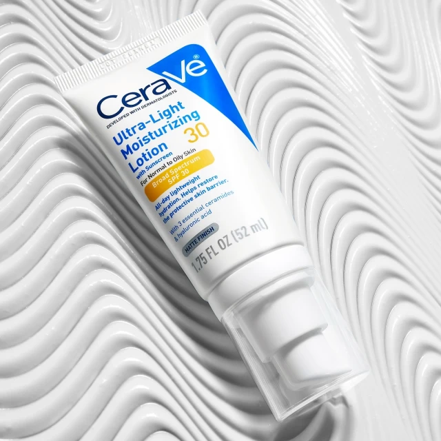 Cerave Ultra-Light Moisturizing Lotion SPF 30 shown against a white textured surface. Beauty, skincare, and sun protection.