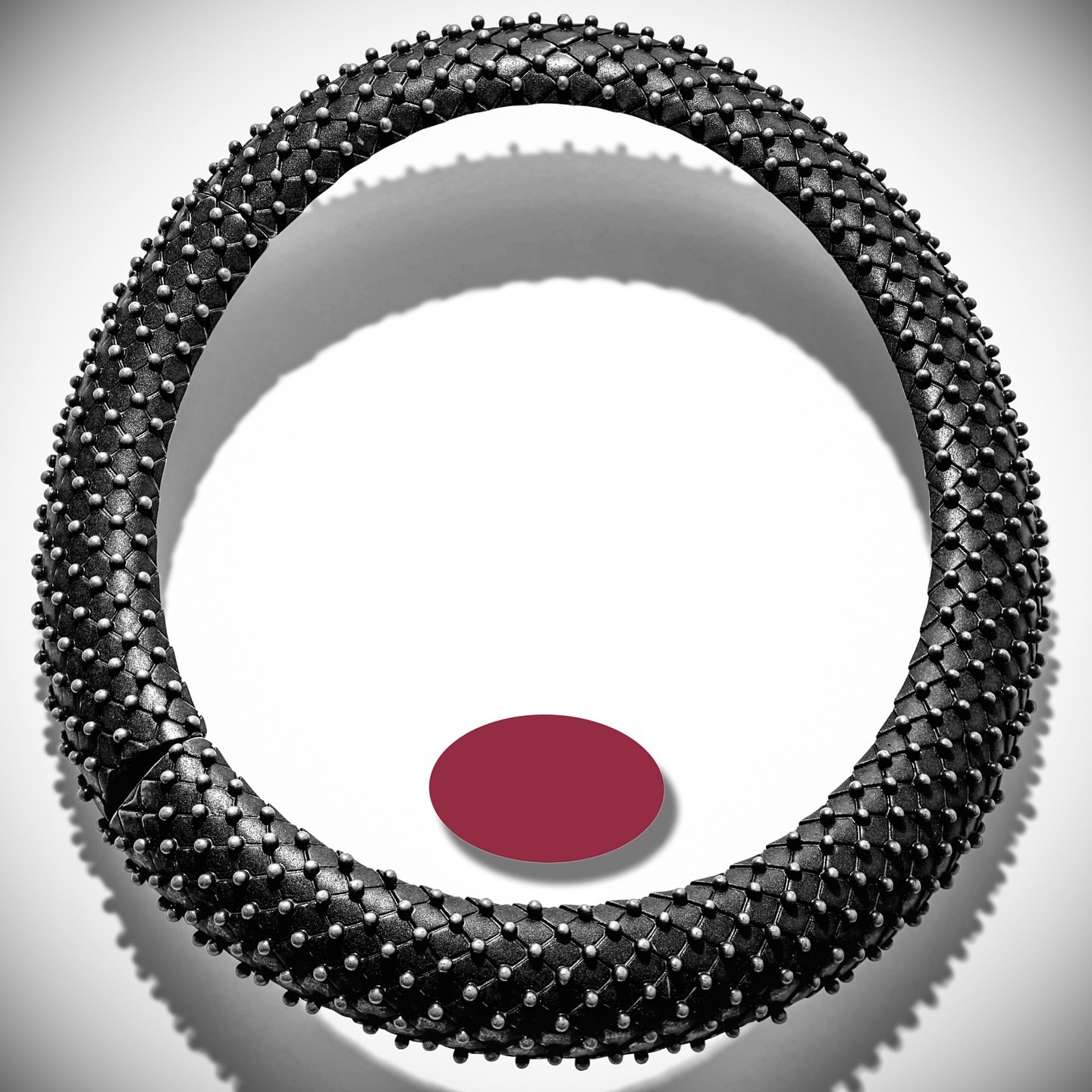 Necklace choker made of woven black leather and silver studs isolated against white background. Product shot for fashion and beauty.