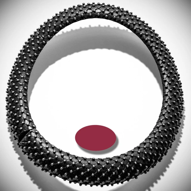 Necklace choker made of woven black leather and silver studs isolated against white background. Product shot for fashion and beauty.