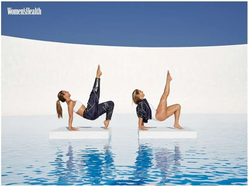 Two adult women in fitness attire practice arm-supported leg lifts atop white platforms in a blue-tiled pool against a white and blue background.