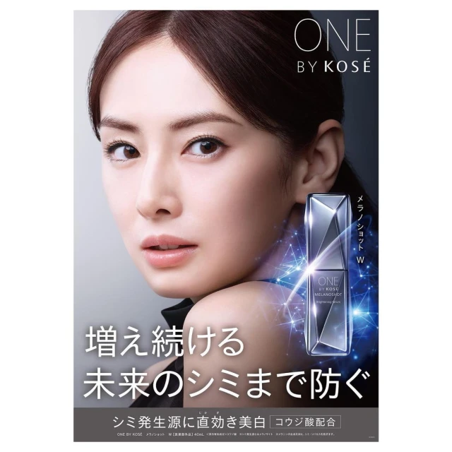 Close-up of Asian woman promoting ONE BY KOSÉ beauty product. Silver and blue serum bottle shown. Japanese text is visible in the lower part of the frame.
