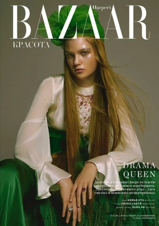 Fashion magazine cover featuring a model with long hair, wearing a green headpiece and dress, with Harper's Bazaar logo.
