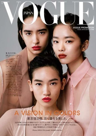 Vogue Japan cover features three young Asian women with bold red lipstick and sheer tops against a light gray backdrop in soft lighting.