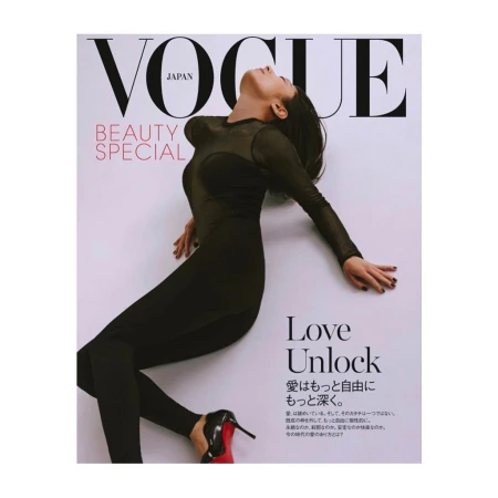 Vogue Japan cover featuring a woman in a black bodysuit and heels, lying against a white background with magazine text elements.