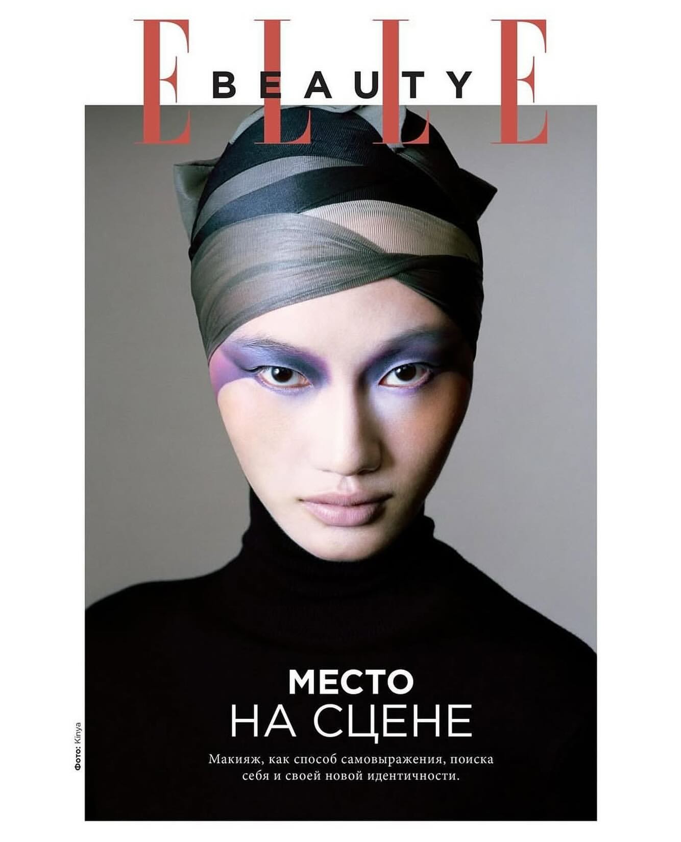Elle Beauty magazine cover featuring a woman with creative makeup and a head wrap, set against a grey backdrop with bold typography.