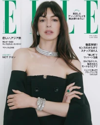 Anne Hathaway on magazine cover wearing a strapless black top, layered diamond necklace, serpent bracelet, and ring.