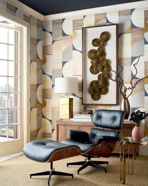 Modern interior with a black leather lounge chair and ottoman set against patterned wallpaper and a window view of the city skyline.