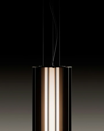 Modern pendant light fixture with a cylindrical shape and a combination of dark and illuminated panels, hanging against a dark background.
