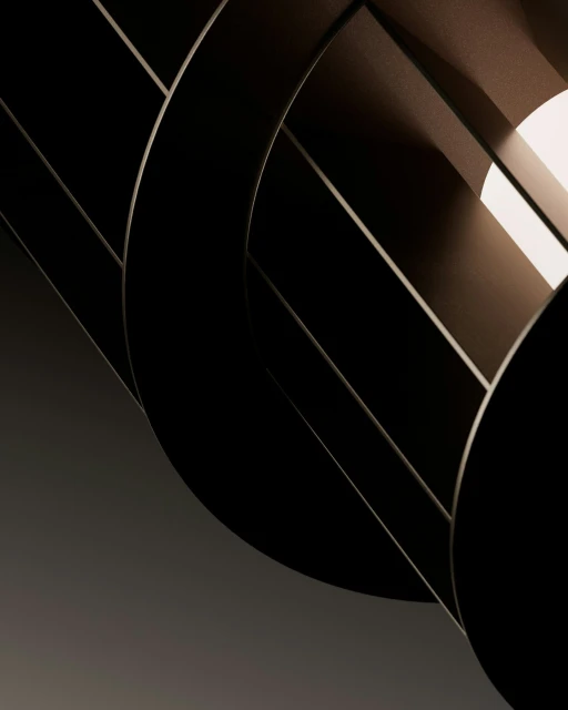 Abstract shot of dark geometric shapes with light and shadow, creating a modern, sophisticated composition with clean lines and depth.