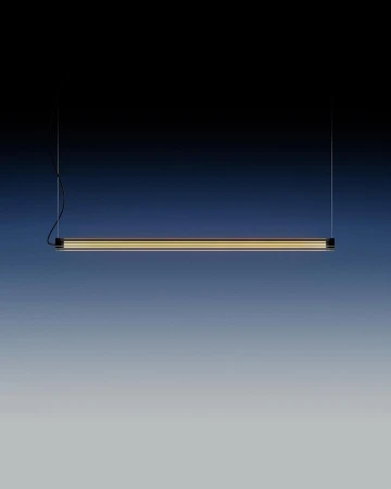 Minimalist black linear suspension light fixture with a diffused golden light element against a dark blue to grey gradient background.