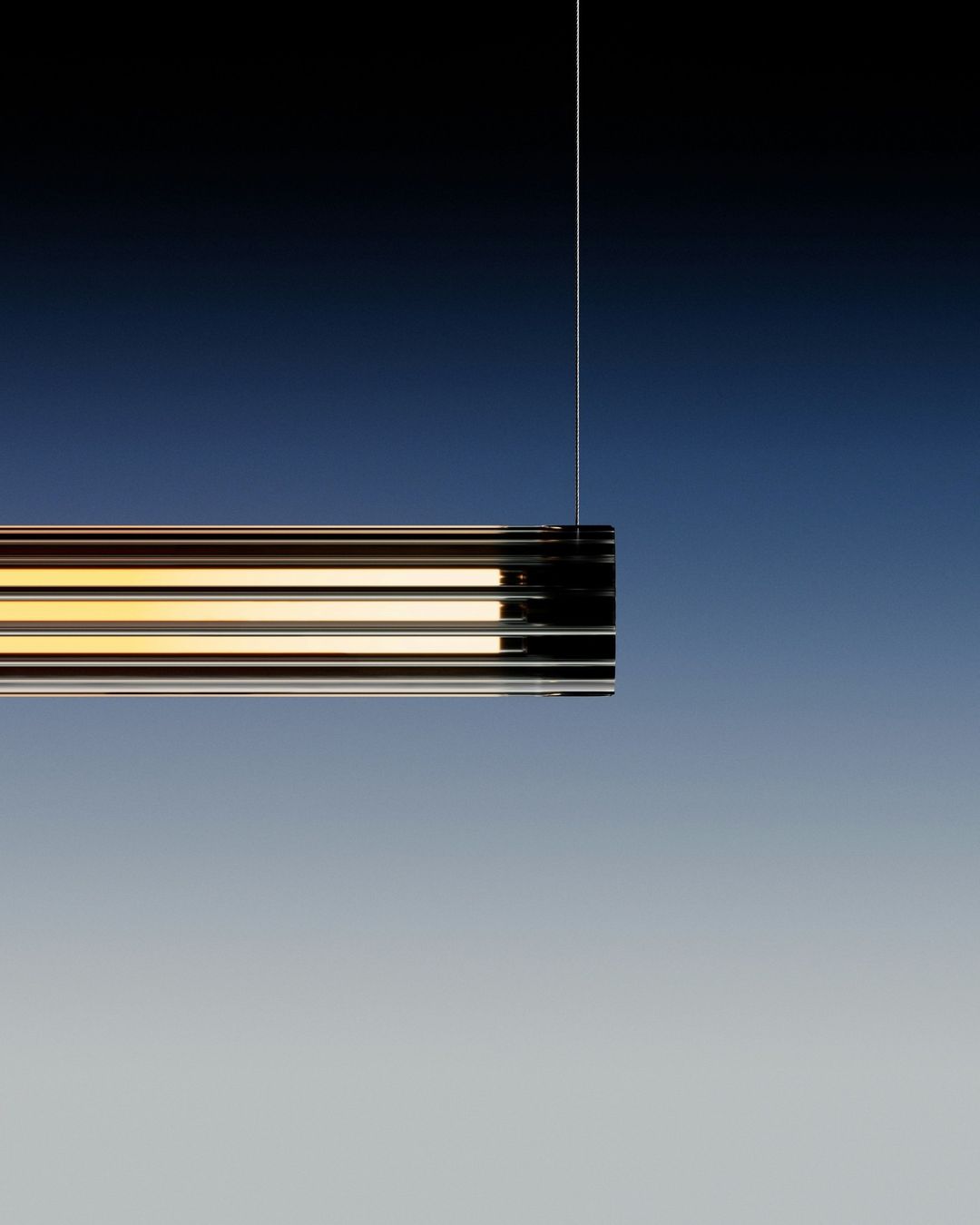 Minimalist interior lighting fixture hanging from a cord against a gradient blue background with a modern, sleek design and warm light.