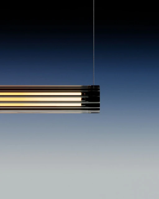 Minimalist interior lighting fixture hanging from a cord against a gradient blue background with a modern, sleek design and warm light.