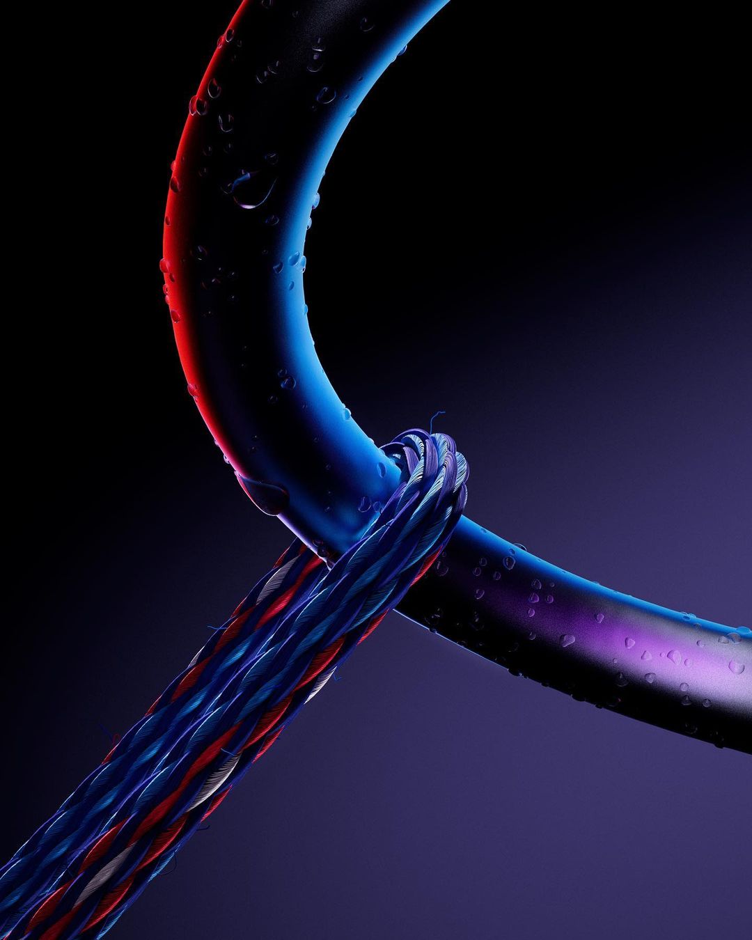 Close-up studio shot of a blue cord intersecting with another blue and red striped cord against a dark background.