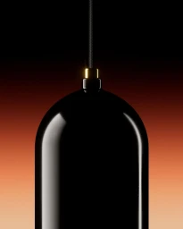 Close-up of a glossy black rounded pendant light fixture hanging against a warm gradient background photographed by Kiwi Bravo