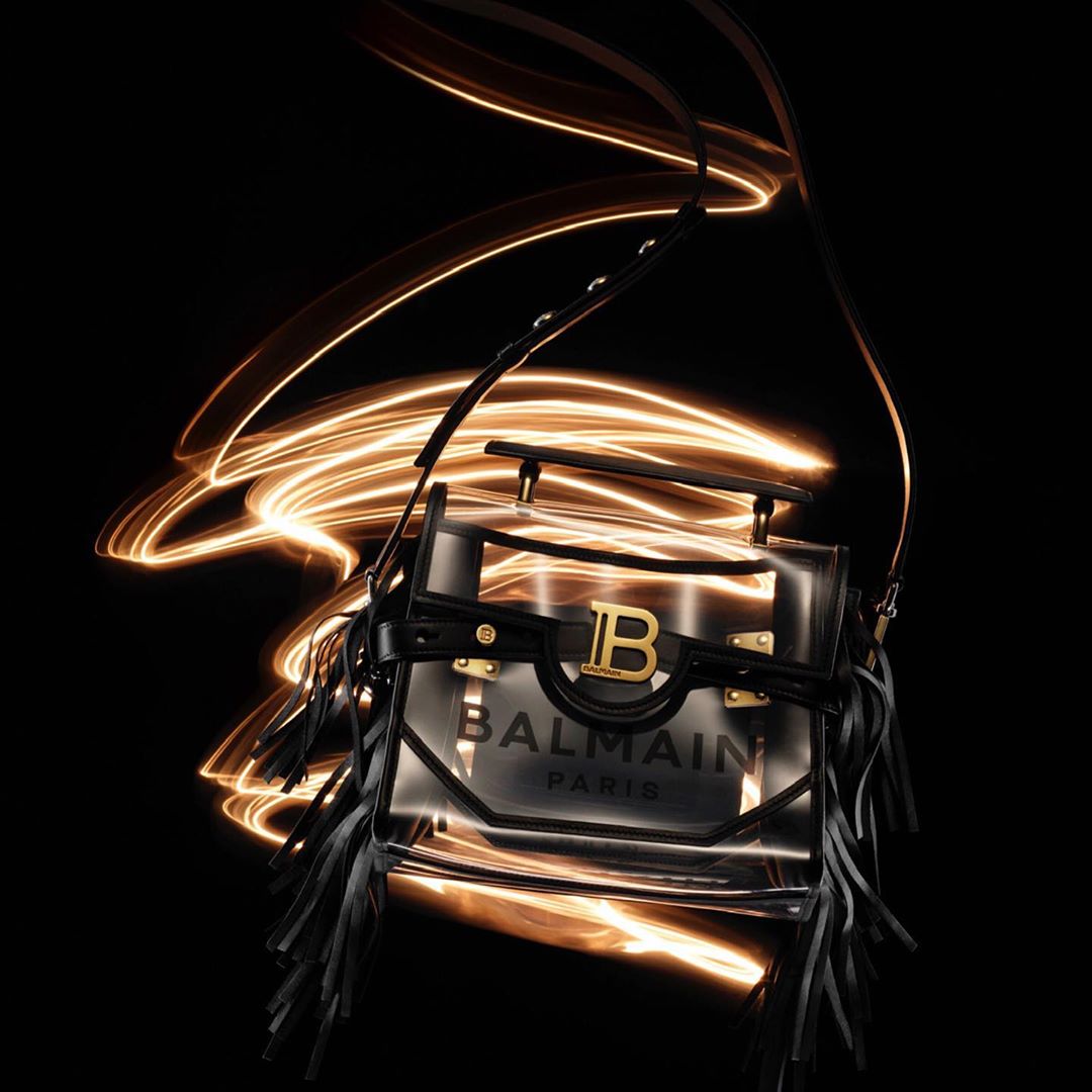 Balmain purse illuminated by light painting against a black backdrop for a fashion brand product shot with luxury appeal and modern style.