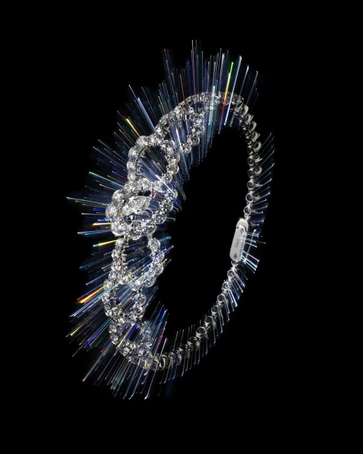 A sparkling diamond bracelet with iridescent light rays on a stark black background creating a dramatic, high-contrast jewelry shot.