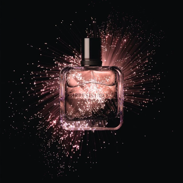 Elegant presentation of a perfume bottle with 'Irresistible Givenchy' displayed against a black backdrop with sparkling light effects.