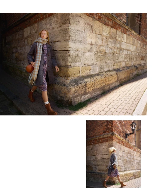 Stylish young woman in patterned dress, brown coat, and boots walks along a cobblestone street next to the corner of a brick building.