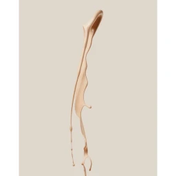 A beige liquid splash captured mid-air against a solid light background, creating an abstract vertical form.