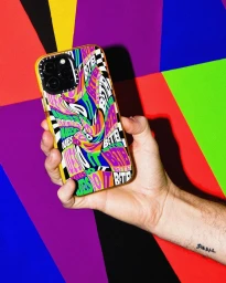 Hand holding a smartphone in a colorful patterned case against a vibrant geometric background