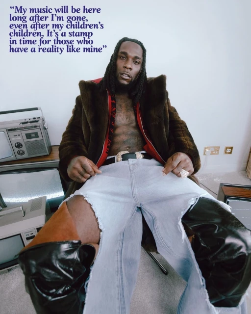 Portrait of a stylish adult male in ripped jeans and a fur coat, posing indoors with vintage TV sets and a quote overlay.