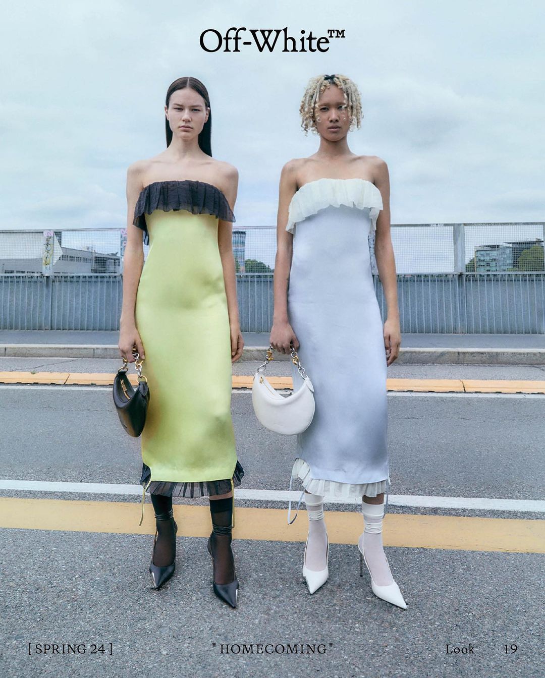 Two fashion models pose in strapless midi dresses with matching mini bags. One wears yellow with black accents, the other light blue with white.