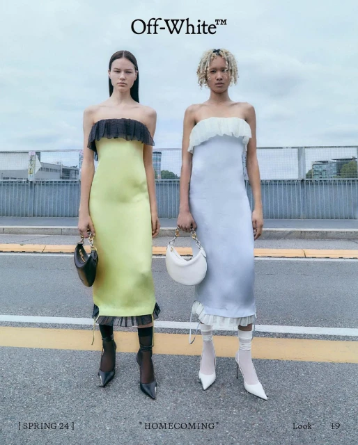 Two fashion models pose in strapless midi dresses with matching mini bags. One wears yellow with black accents, the other light blue with white.