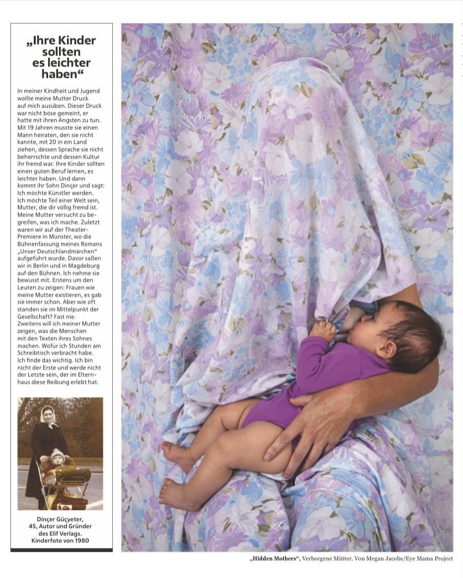 Woman holding a baby. The woman is draped in a blue and white floral patterned cloth.  Photo taken from a magazine.