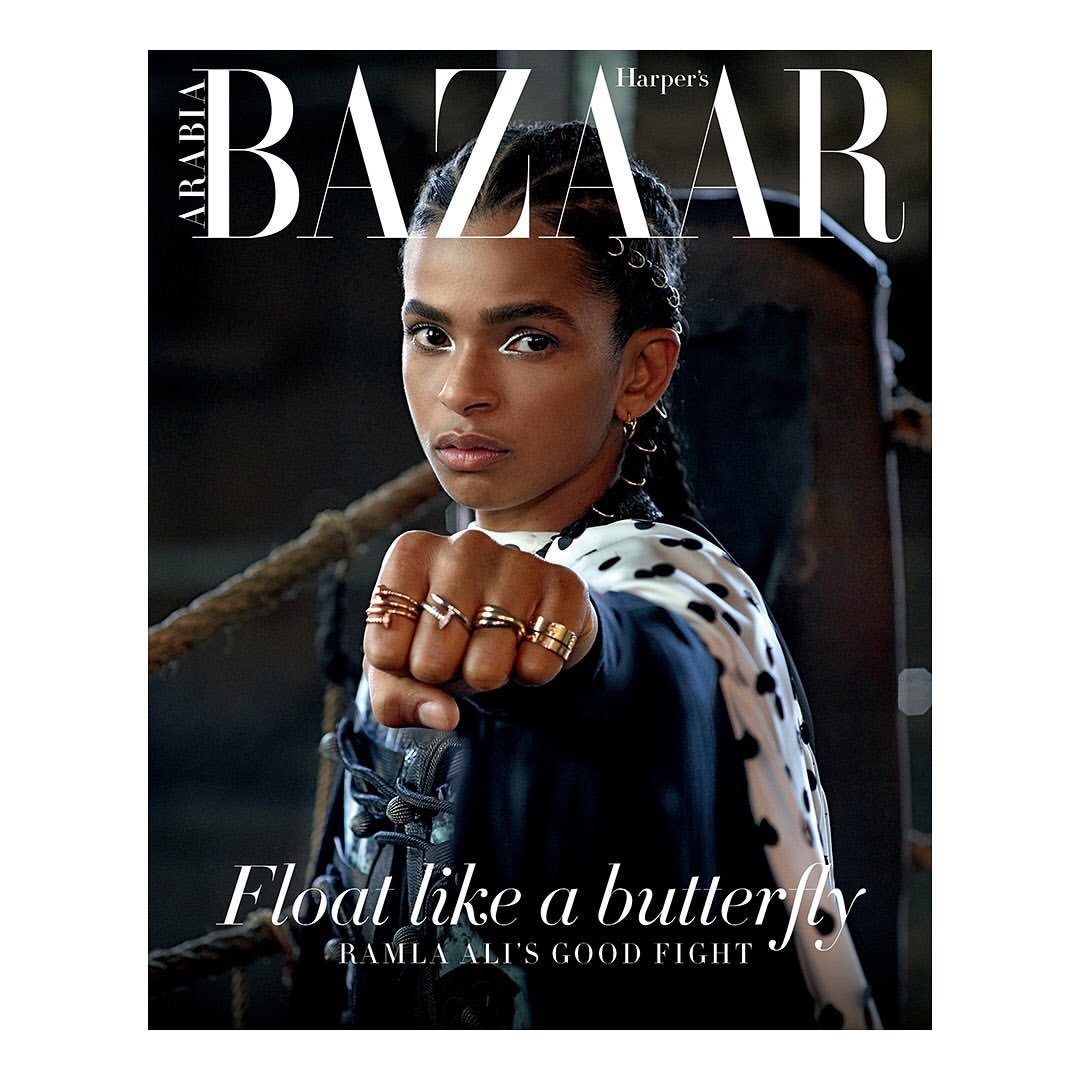 Magazine cover featuring Ramla Ali with a determined facial expression, wearing rings and a patterned jacket against a dark backdrop.