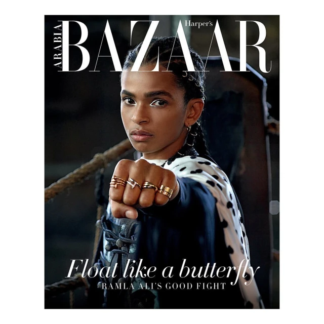 Magazine cover featuring Ramla Ali with a determined facial expression, wearing rings and a patterned jacket against a dark backdrop.