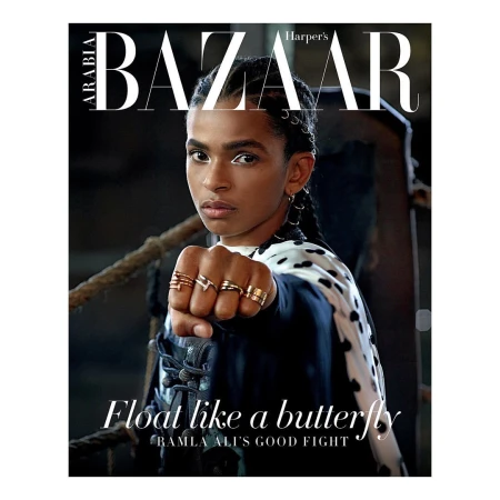 Magazine cover featuring Ramla Ali with a determined facial expression, wearing rings and a patterned jacket against a dark backdrop.