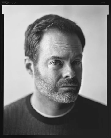 Black and white portrait of Bill Hader looking intently at the camera against a plain light background