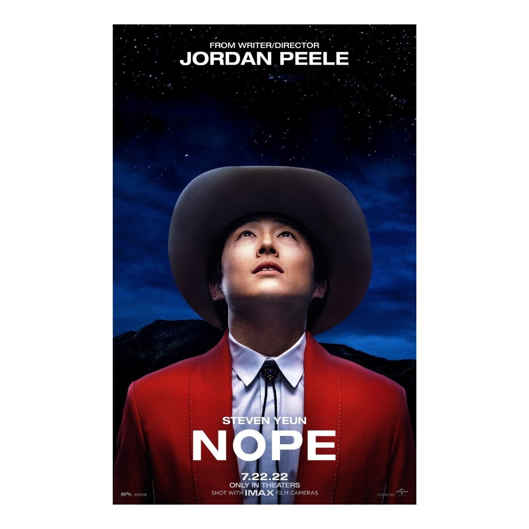 Movie poster for 'Nope' featuring Steven Yeun in a red jacket and cowboy hat, set against a starry night sky and mountain background.