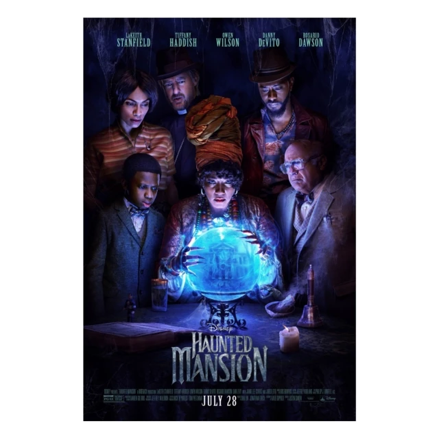 Movie poster for Disney's Haunted Mansion film featuring a group of adults and a child with a glowing crystal ball.