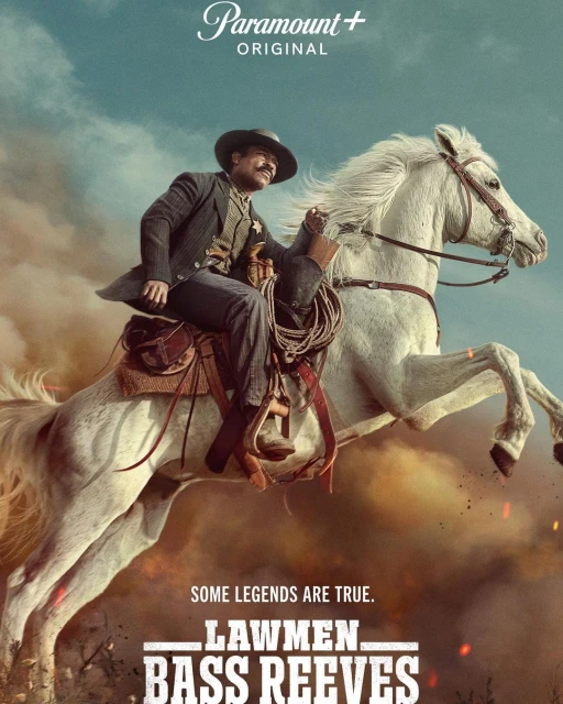 Poster for Paramount+'s Lawmen: Bass Reeves, featuring an African-American man in western wear riding a white horse against a dusty background.