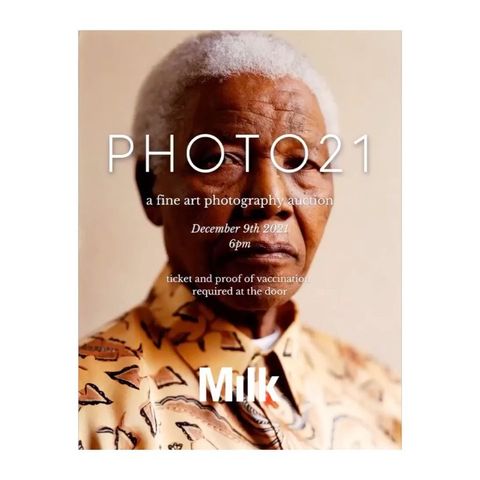 Elderly African American man poses for a fine art photography auction promo, wearing patterned shirt, in a medium indoor shot.