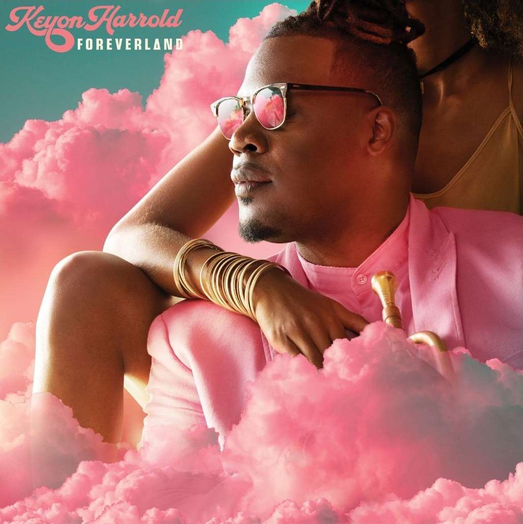 Album cover art: Dark-skinned man with glasses and gold bracelets in a pink suit posing with a woman against a backdrop of clouds.