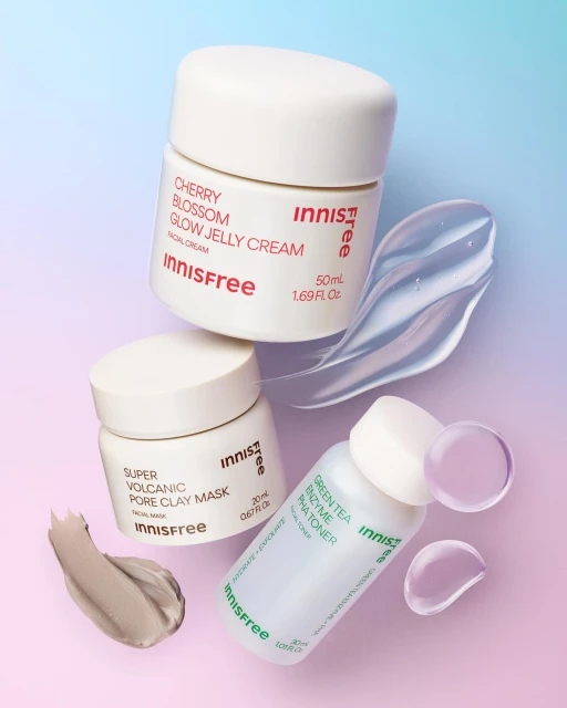 Innisfree skincare products including cherry blossom glow jelly cream, volcanic pore clay mask, and green tea enzyme ph toner on gradient backdrop.
