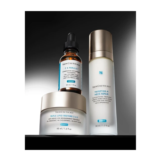 Three Skinceuticals bottles of skincare products are arranged on a dark background with a serum, cream, and lotion.