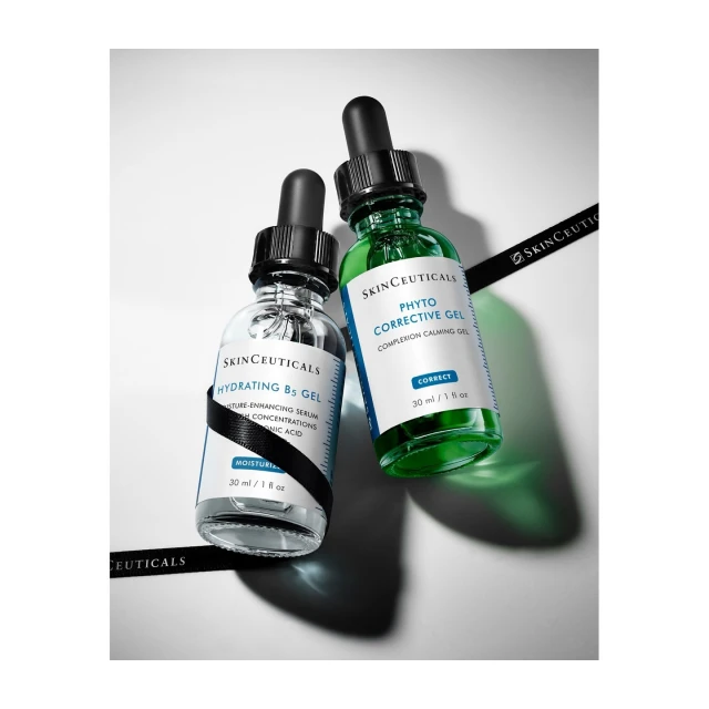 Two skincare serum bottles, one green and one clear, angled diagonally on a white surface with the brand SkinCeuticals visible.