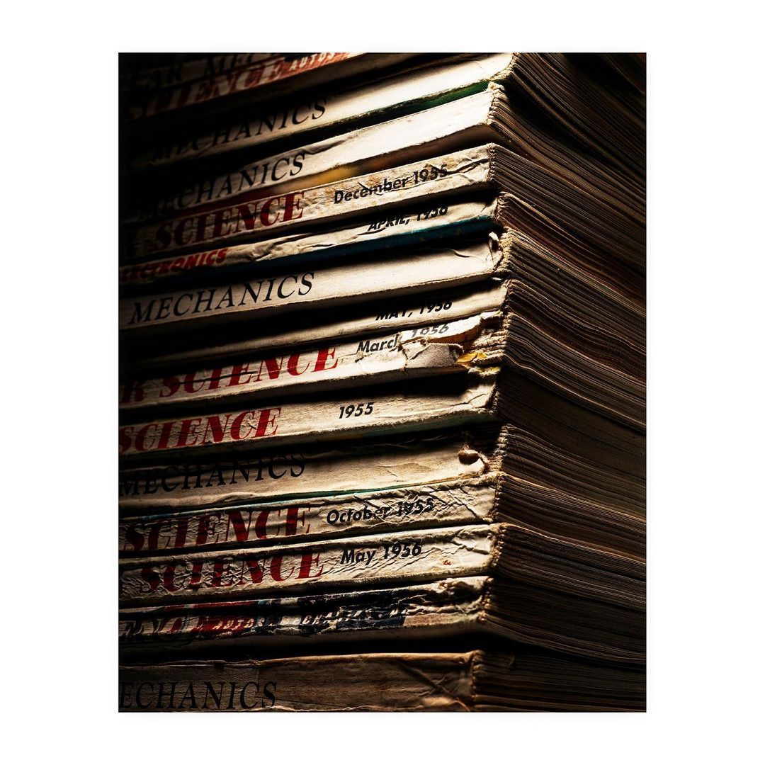 Stack of vintage Popular Science and Mechanics magazines with aged covers, creating a sense of nostalgia and the history of science.