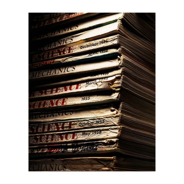 Stack of vintage Popular Science and Mechanics magazines with aged covers, creating a sense of nostalgia and the history of science.